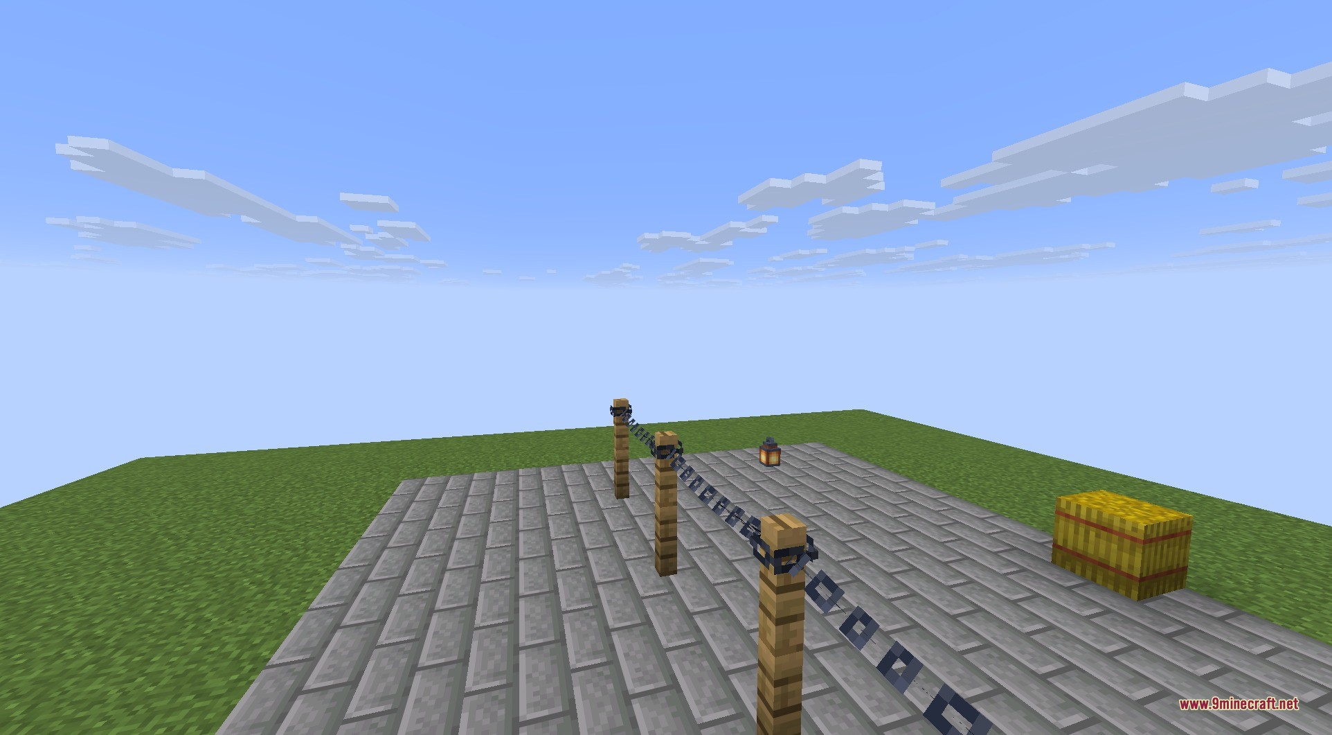 Connectible Chains 9minecraft Mod Screenshot 7 Wooden fence posts connected by sagging iron chains on a stone brick platform