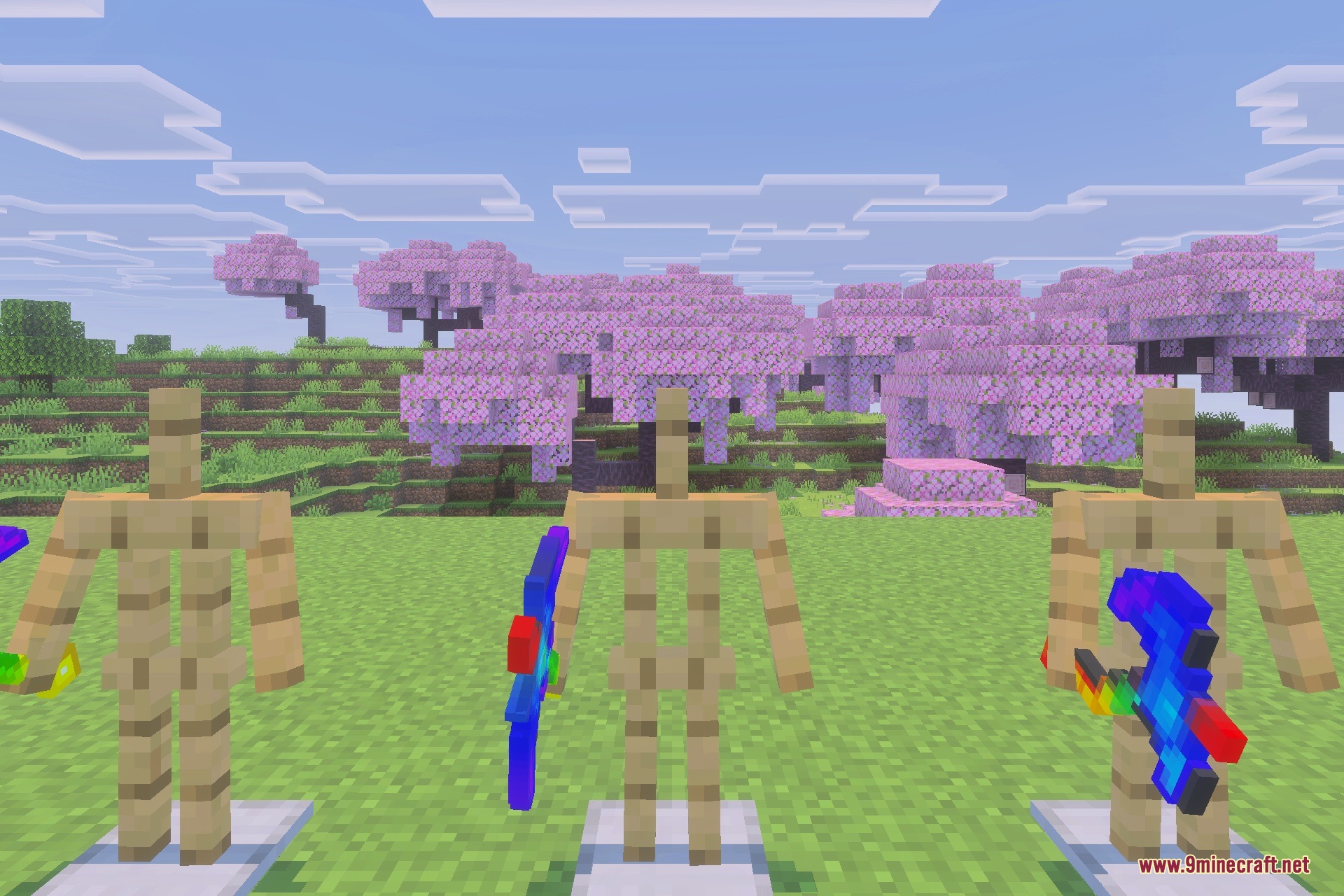 Three armor stands display colorful overpowered tools in a cherry blossom biome
