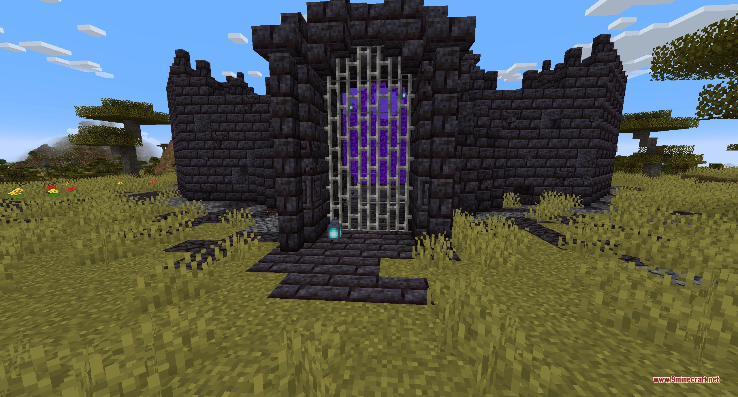 A blackstone fortress gate in the savanna biome containing a Nether portal