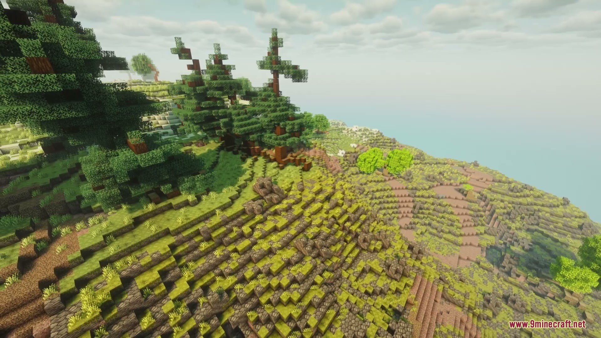 A hilly Minecraft pine forest biome with rocky terrain under a cloudy sky