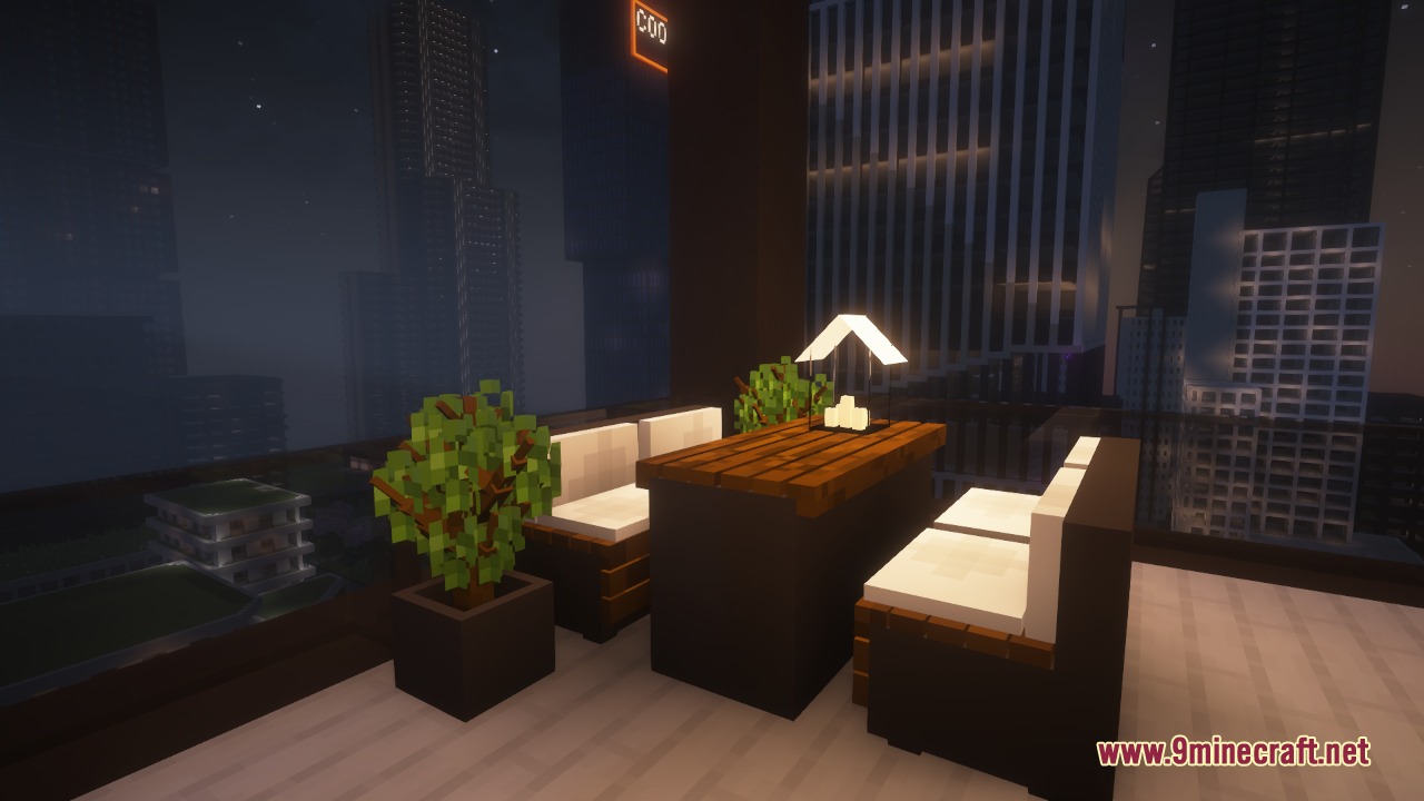 Modern outdoor terrace with seating and potted plants overlooking a city at night