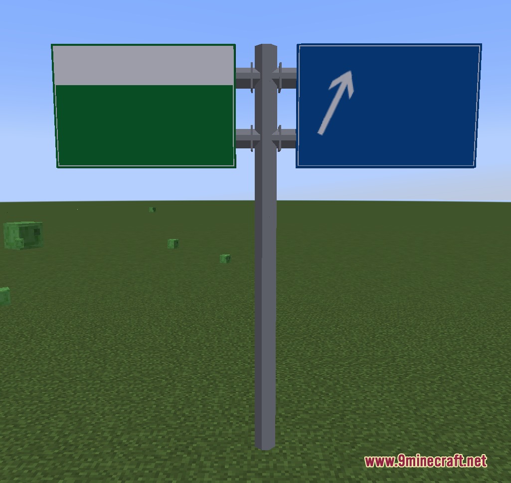 Directional road signs with green and blue boards on a tall grey pole