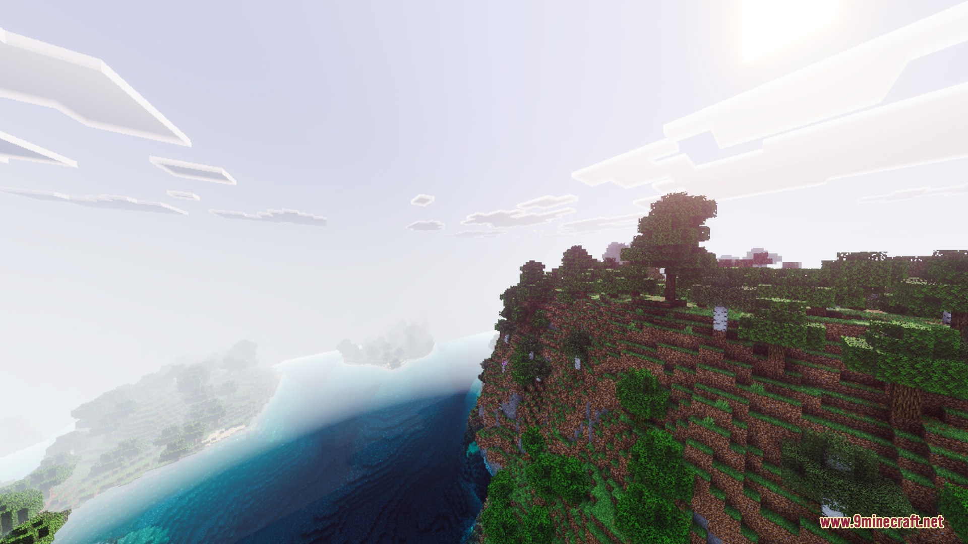 Realistic sunlight shines over a steep cliff and blue water in Minecraft