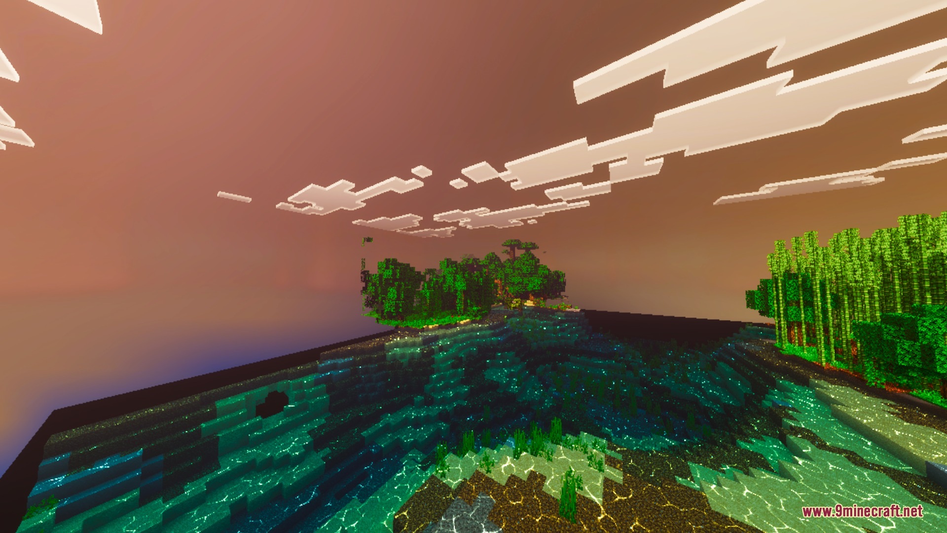 Tropical island with jungle trees and bamboo under a deep red sunset sky