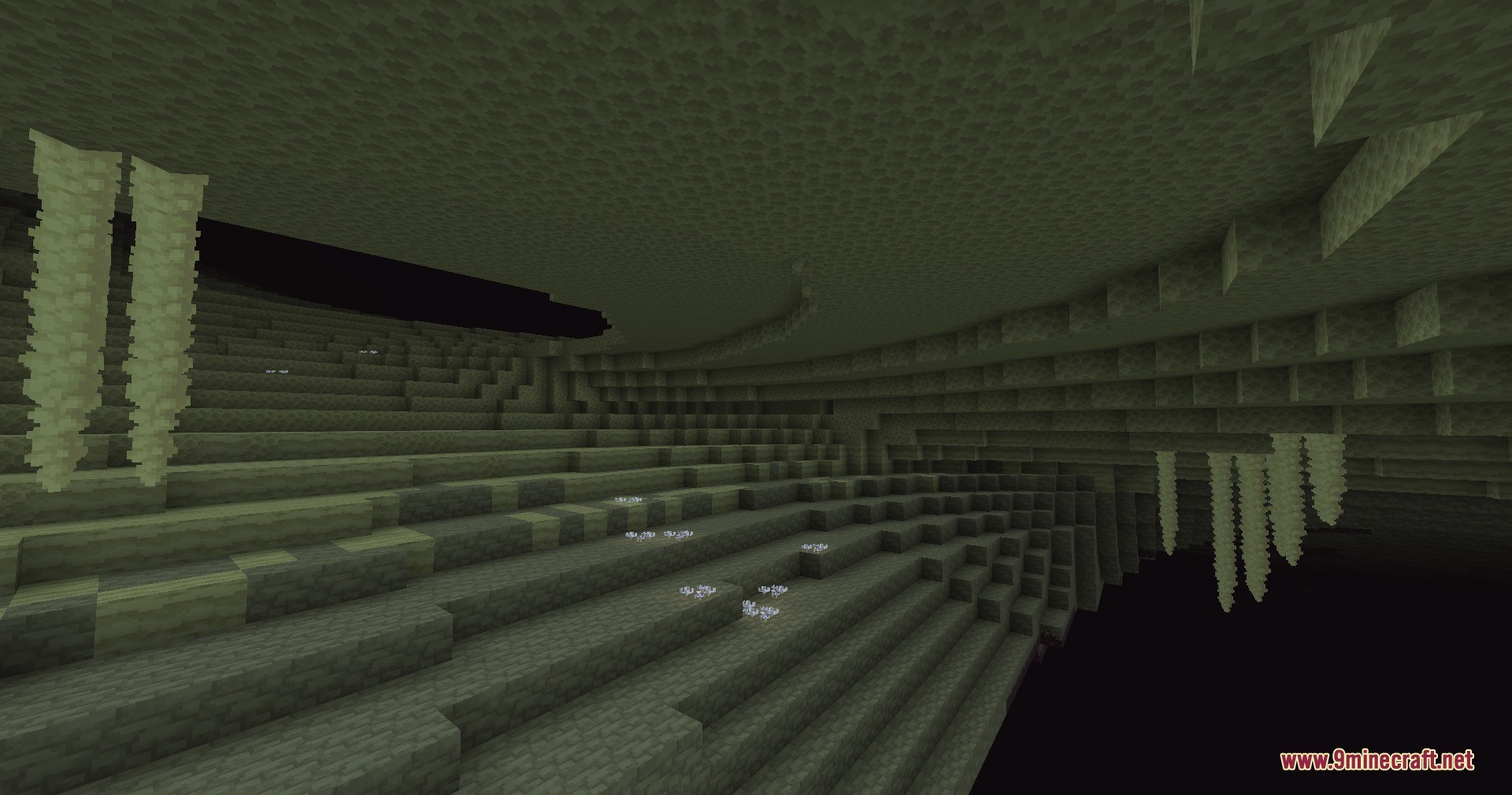 Ender Horizon Expand Mod Screenshot 7 End stone cavern featuring large stalactites and glowing white flora on the ground