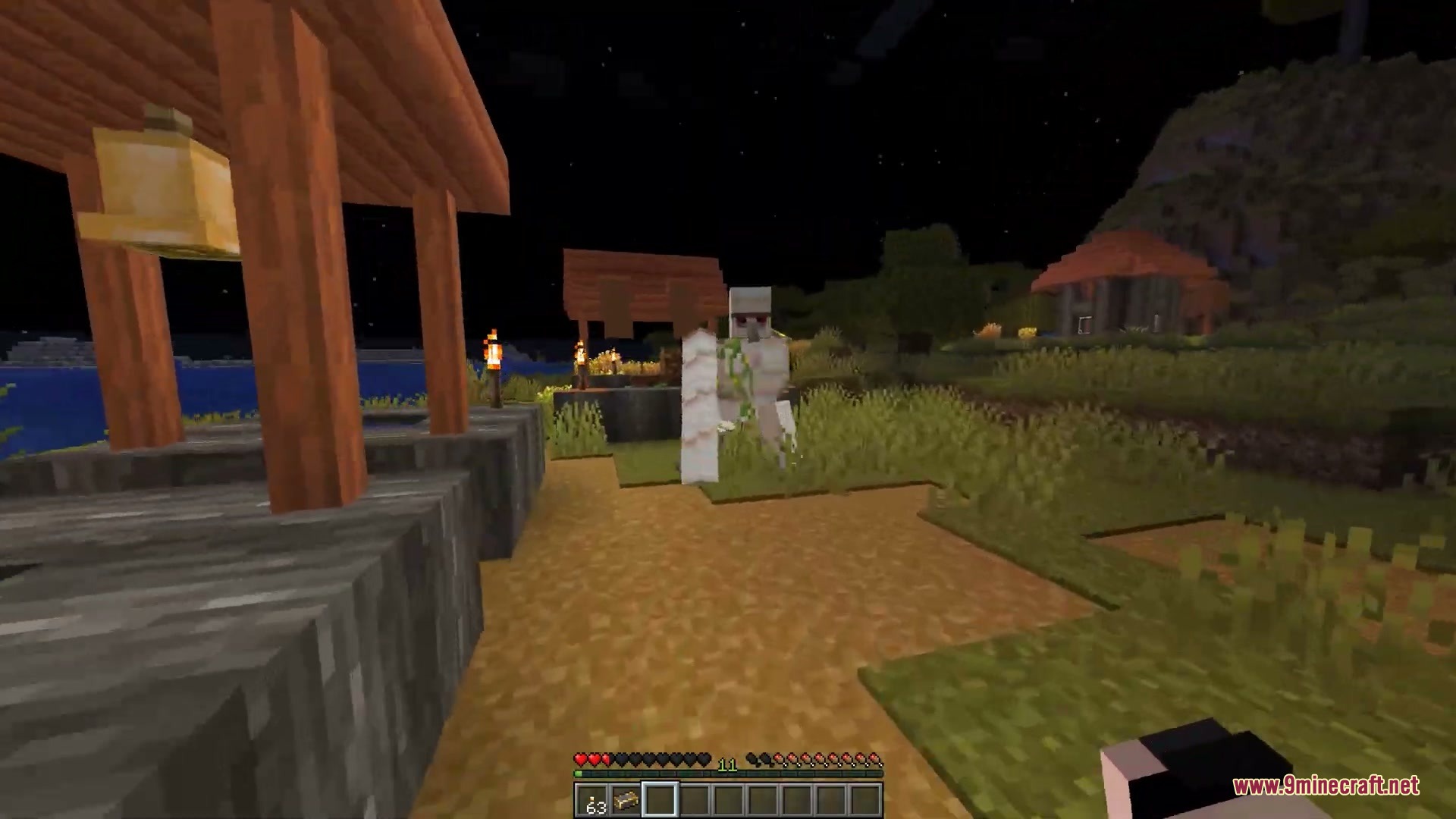Faceless Persona Mod Screenshot 9 A player disguised as an Iron Golem stands in a village at night