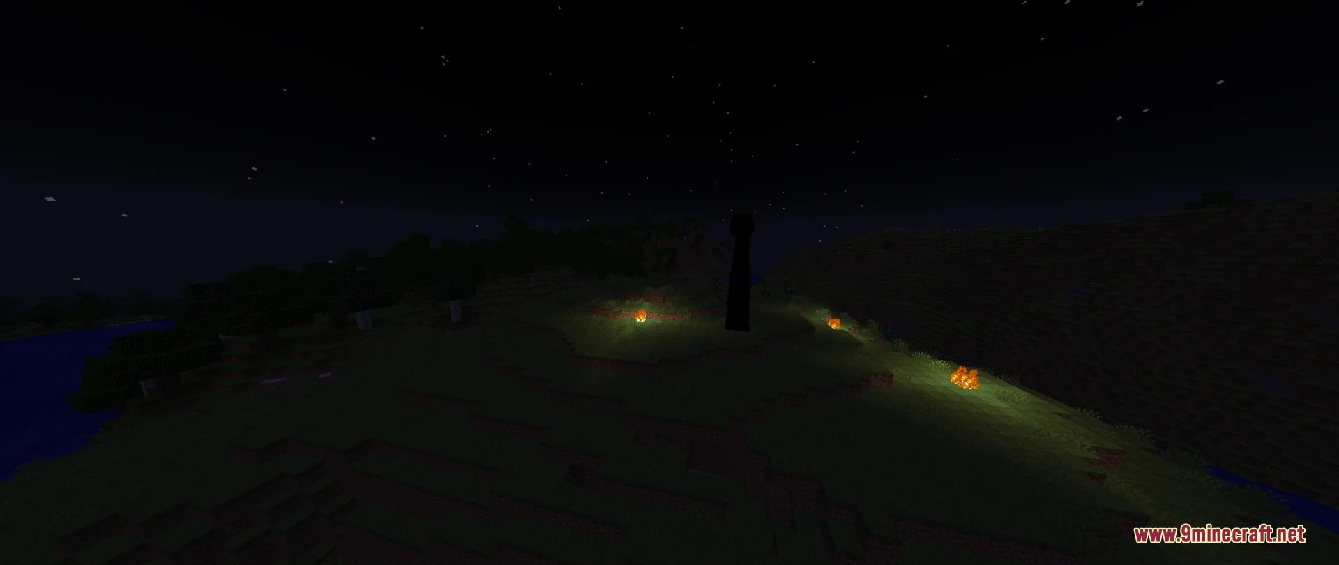 Small fires burn on the ground near a mysterious tall black entity