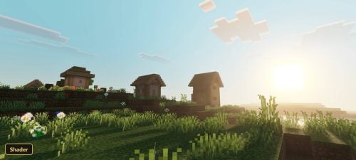 village houses on a grassy hill at sunrise, clear sky