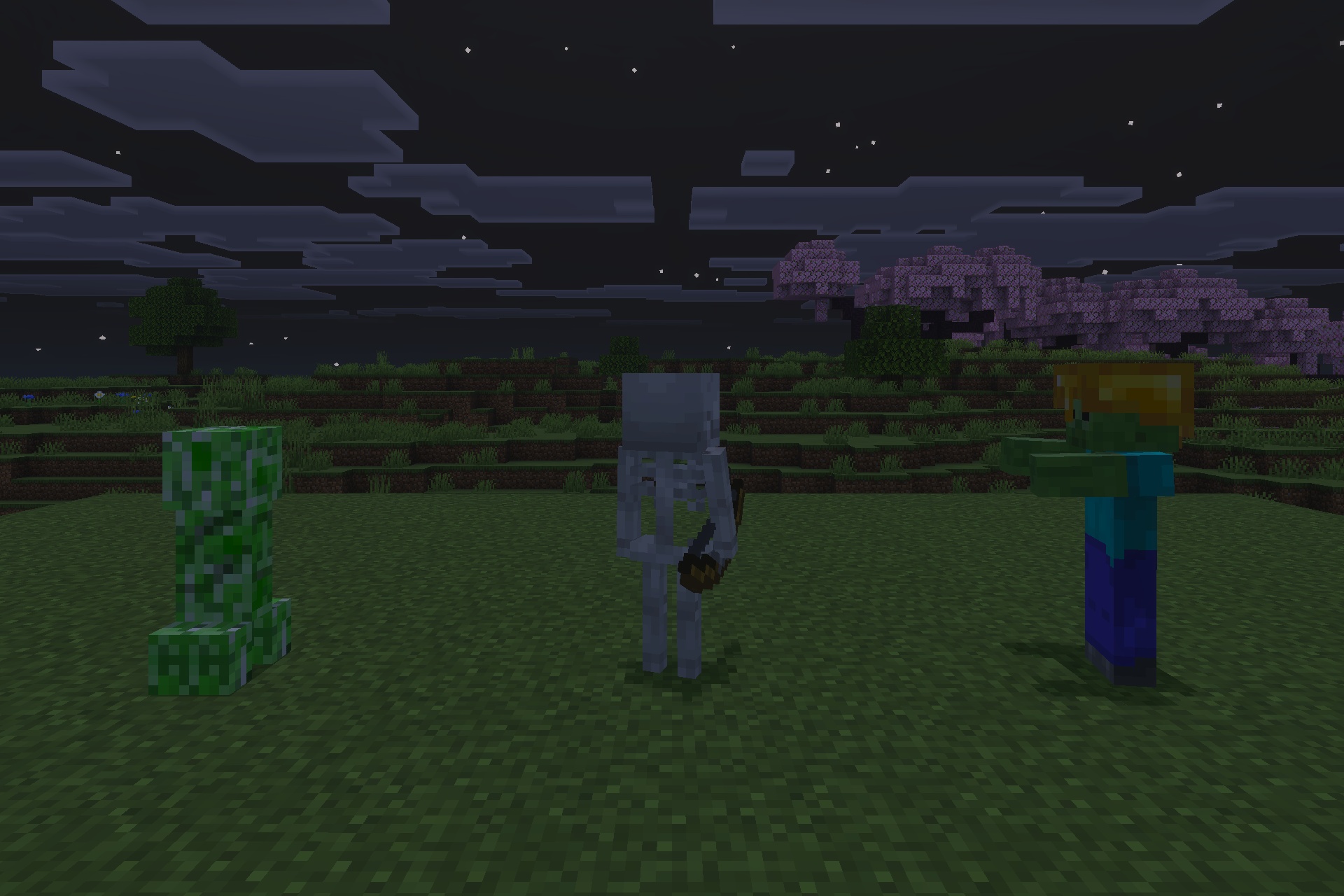 Hostile mobs standing in a field under a clear night sky