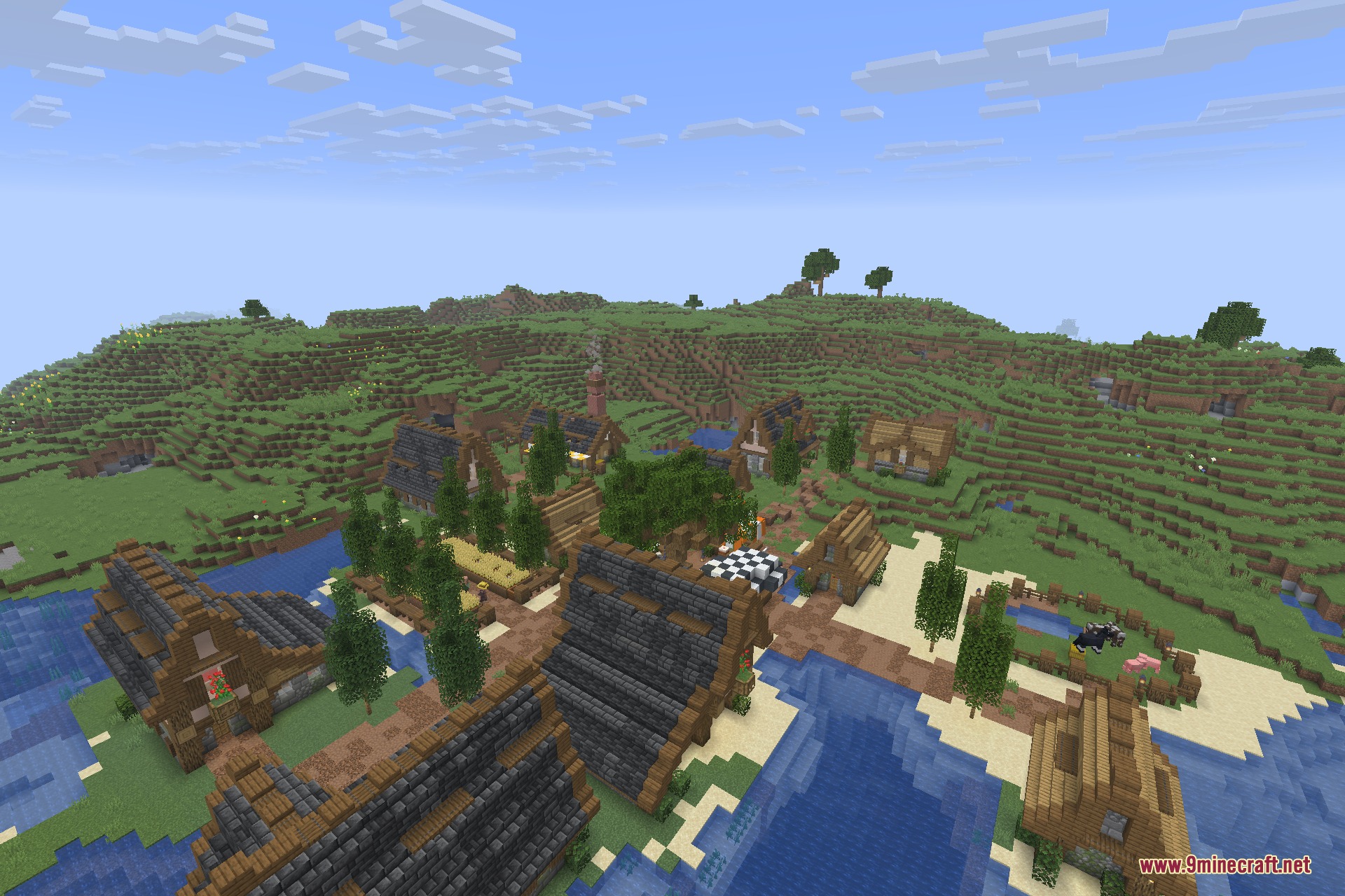 Aerial view of a sprawling village with unique architectural designs and gardens