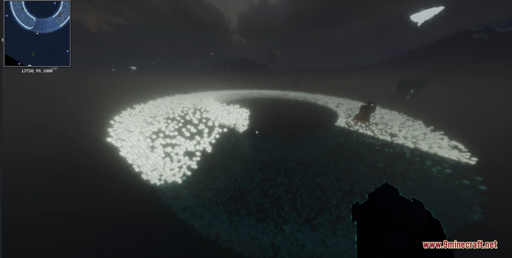 Aerial view of glowing blocks forming a circular path in the sea