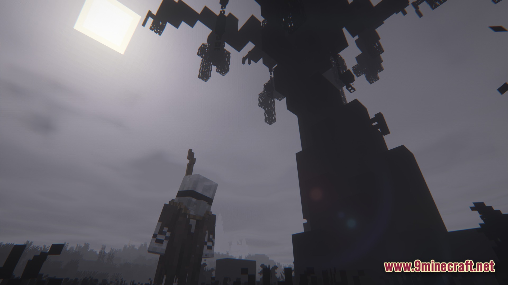 Grimsoul Unleashed Modpack Screenshot 10 A player character stands beneath a large dark tree with hanging cages under a grey sky