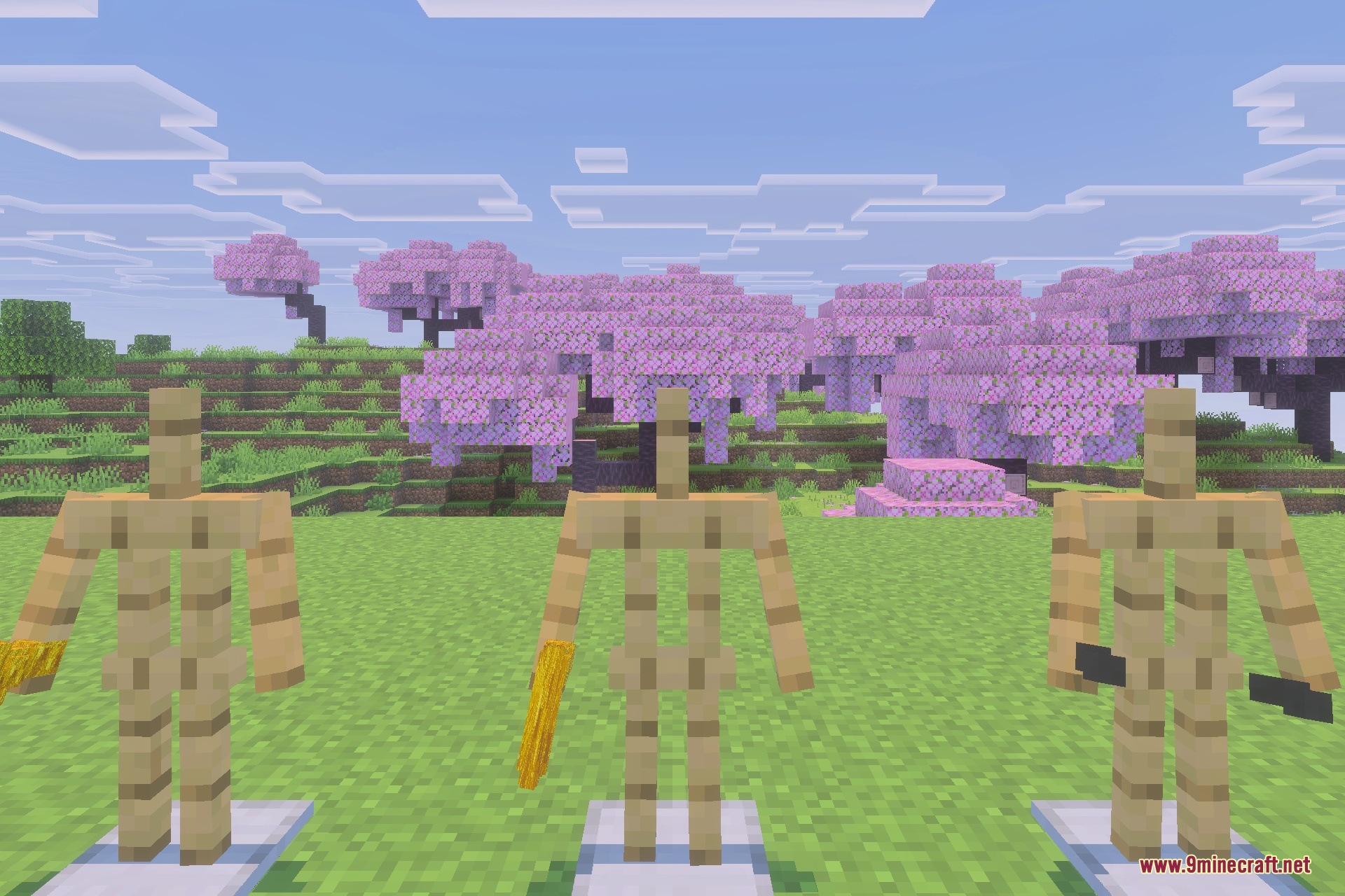 Three armor stands displaying gold firearms and dual guns in a cherry grove