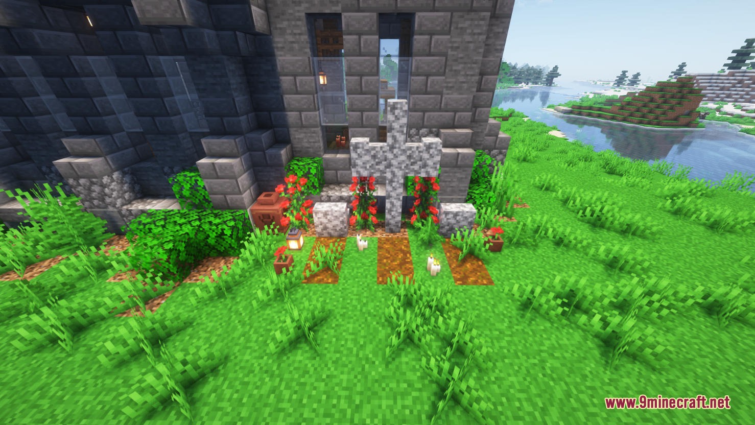A detailed stone cross and flower garden in a small church graveyard