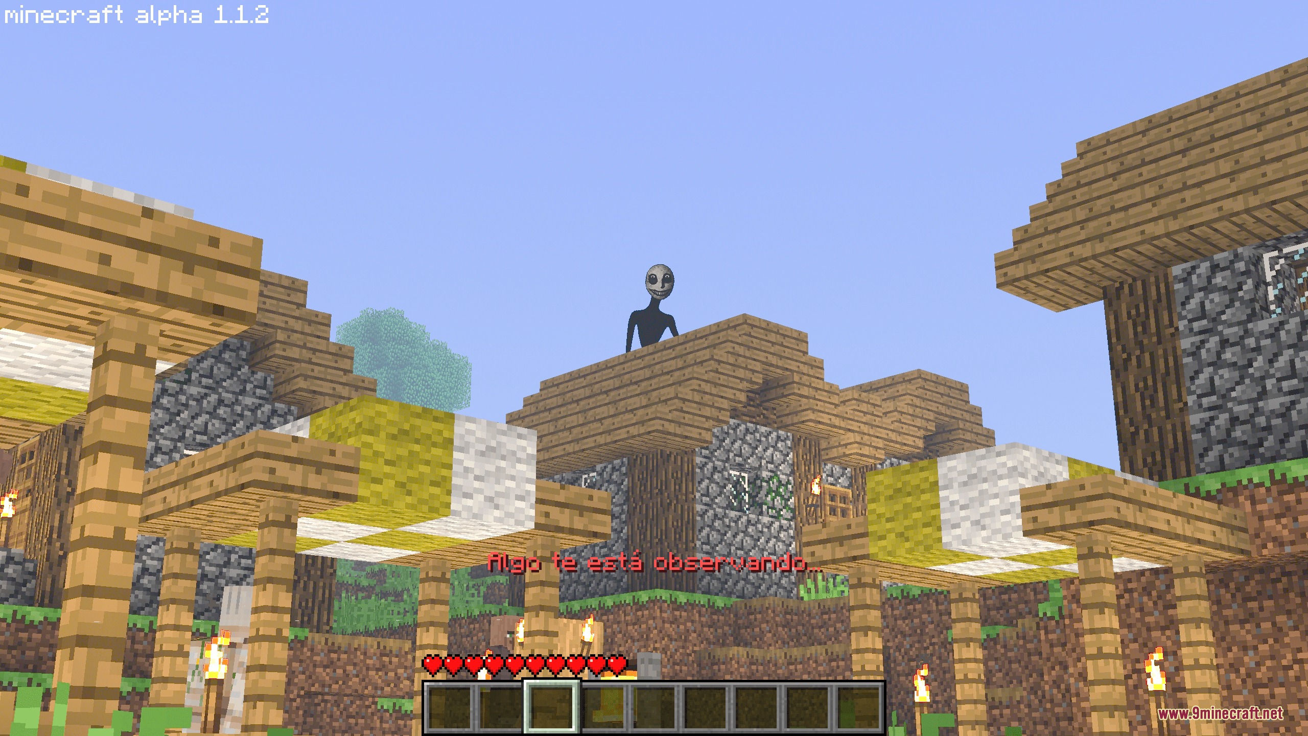 Hollow Watcher Chronicles Mod Screenshot 4 A tall dark entity watches the player from the roof of a village house