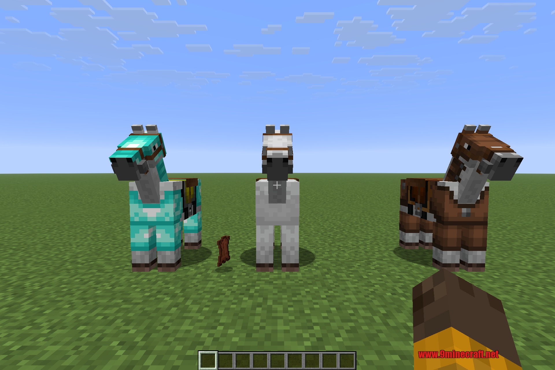 Three horses wearing leather, gold and diamond armour