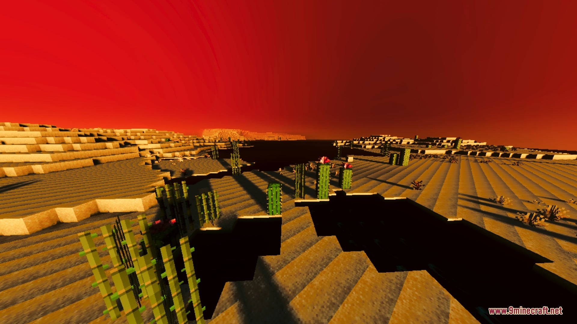 A dramatic red sky glows over a desert biome with tall cacti