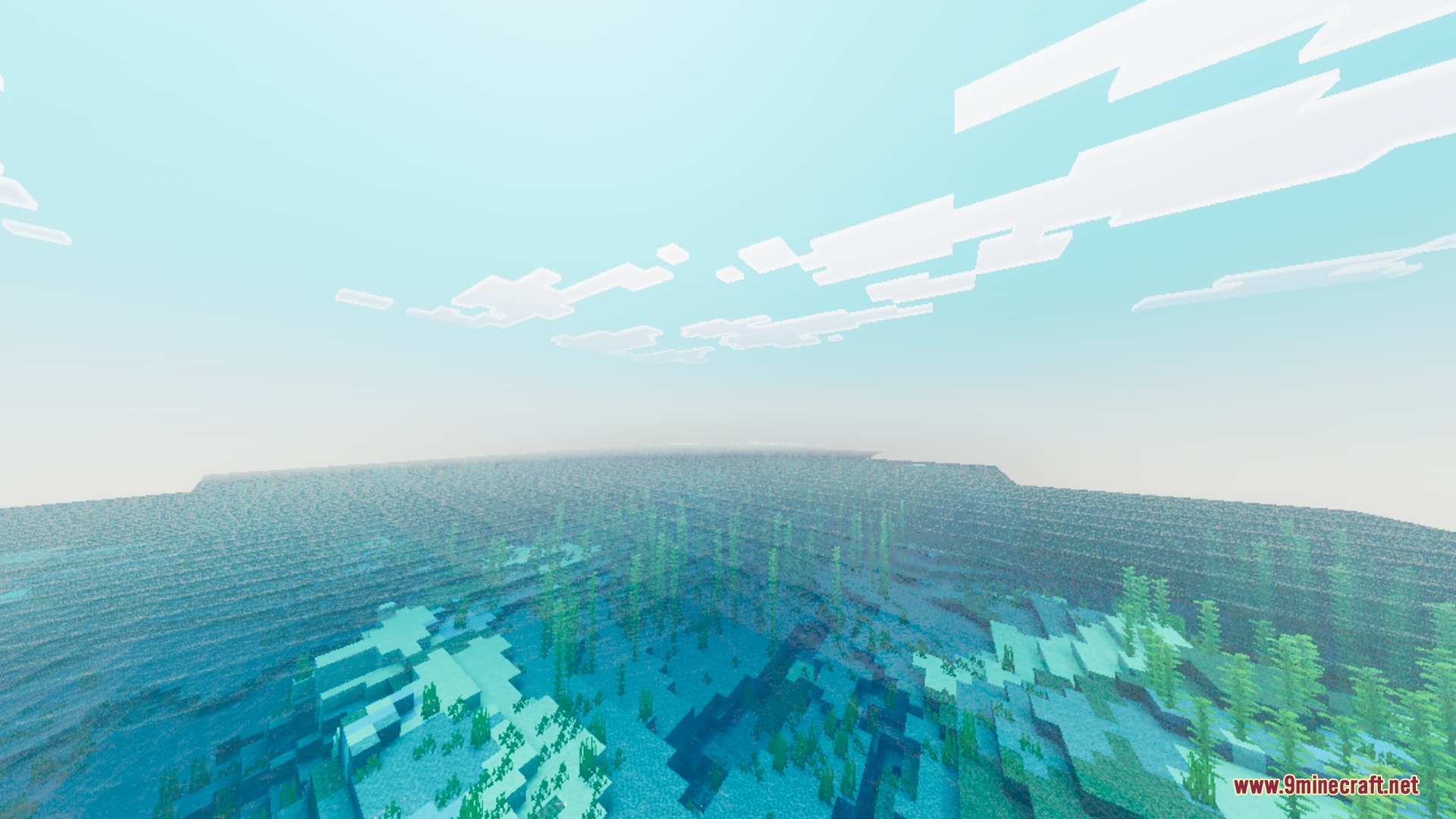 Vibrant blue ocean with kelp visible underwater under a clear blocky sky