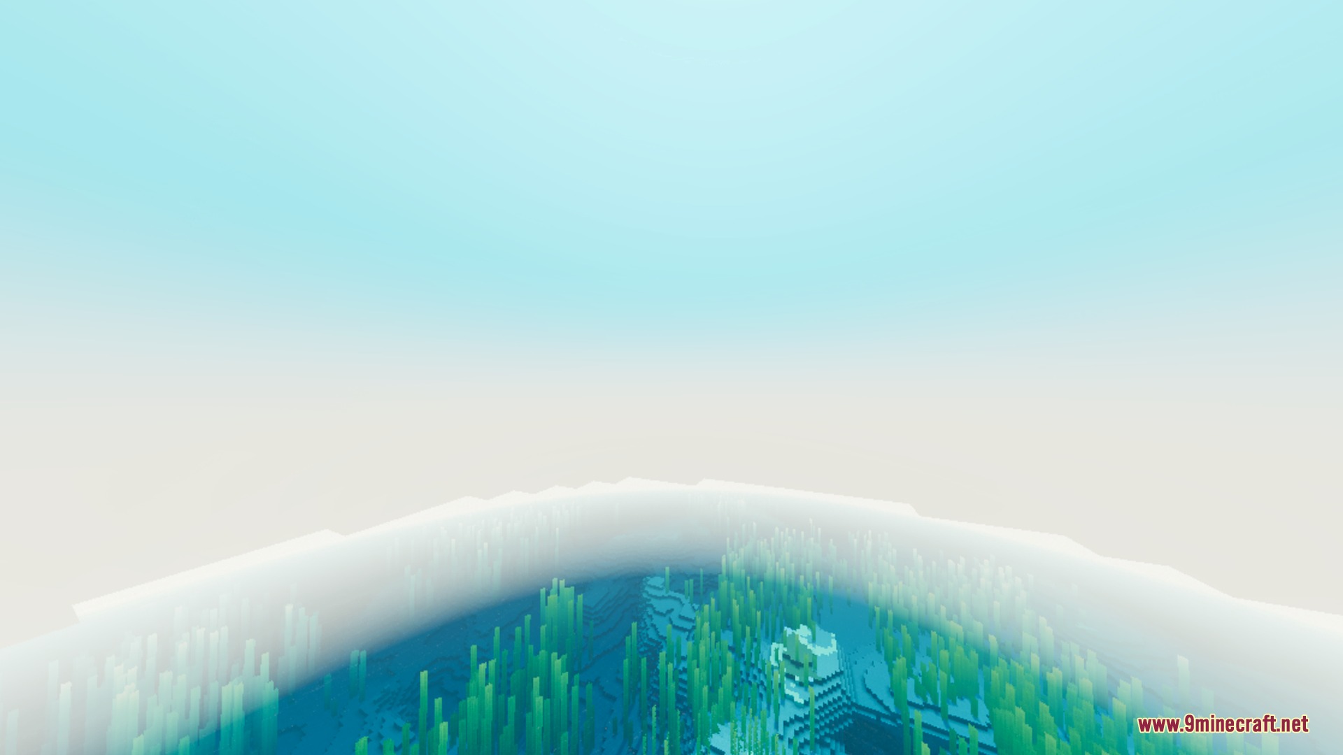Bright sunlight filters through thick fog over a clear blue ocean with kelp