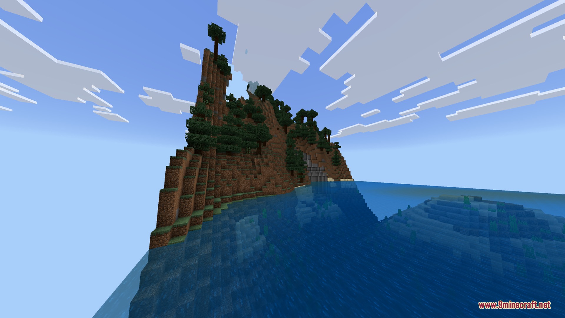 A steep mountain cliff next to a deep blue ocean under clouds