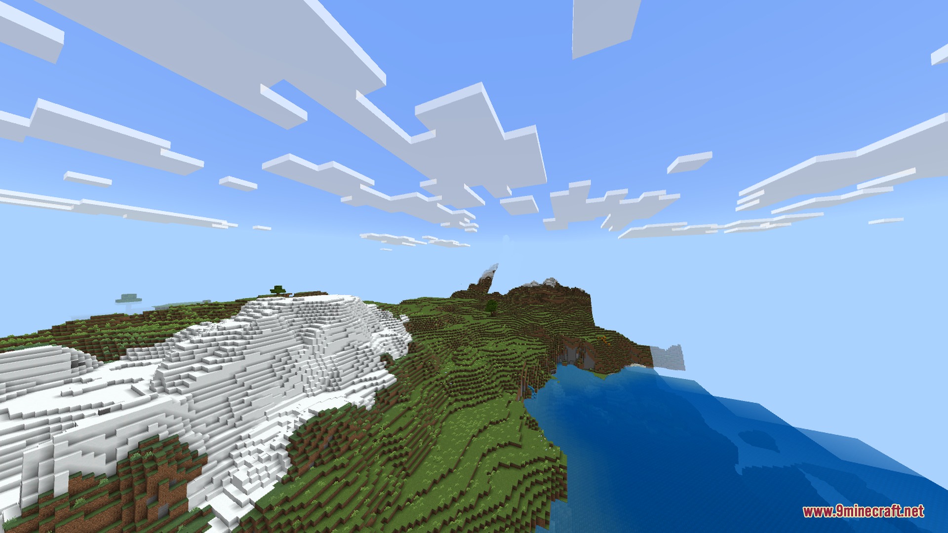 A wide daytime view of snowy mountains and a blue ocean in Minecraft