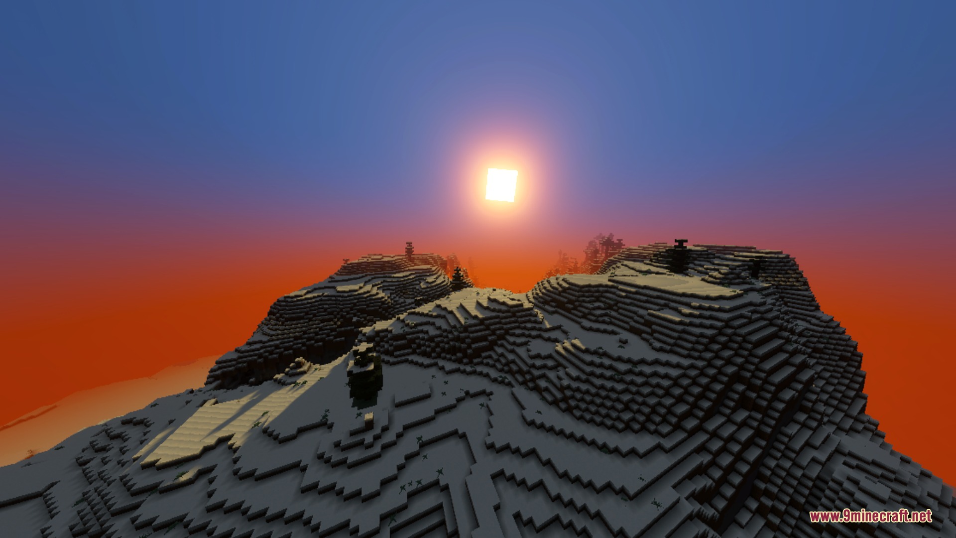 A beautiful sunset over a snowy mountain peak with rich orange color tones