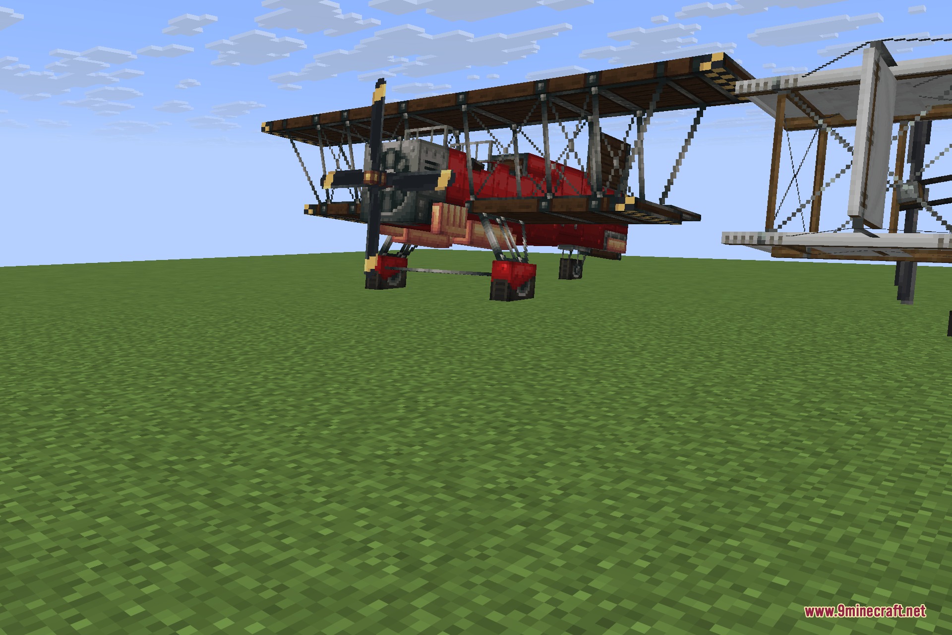 Man of Many Planes 9minecraft Mod Screenshot 2 A red biplane and a wooden aircraft parked on a grass field