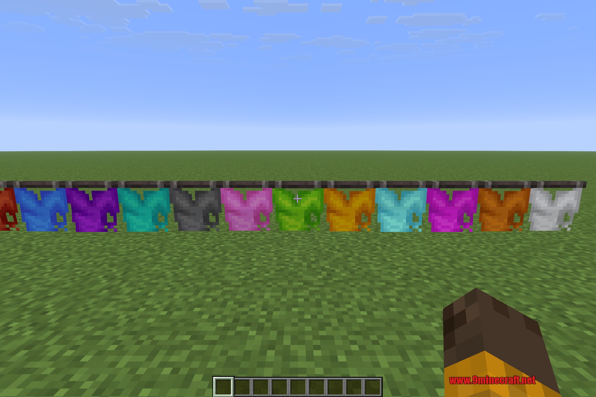 A row of ribbon flags in every dye colour, strung along a wall