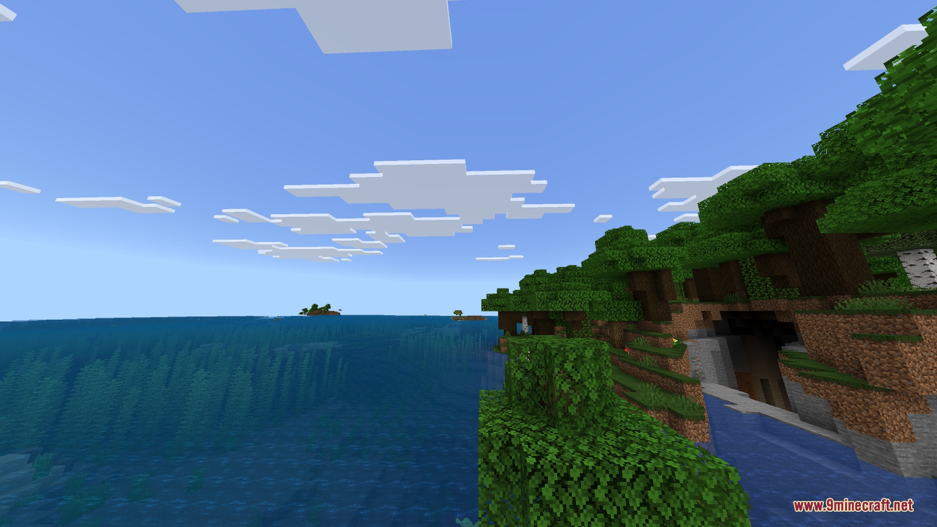 Minecraft Japanese Tools Shader Screenshot 2 A lush green forest biome bordering a vast blue ocean under clouds