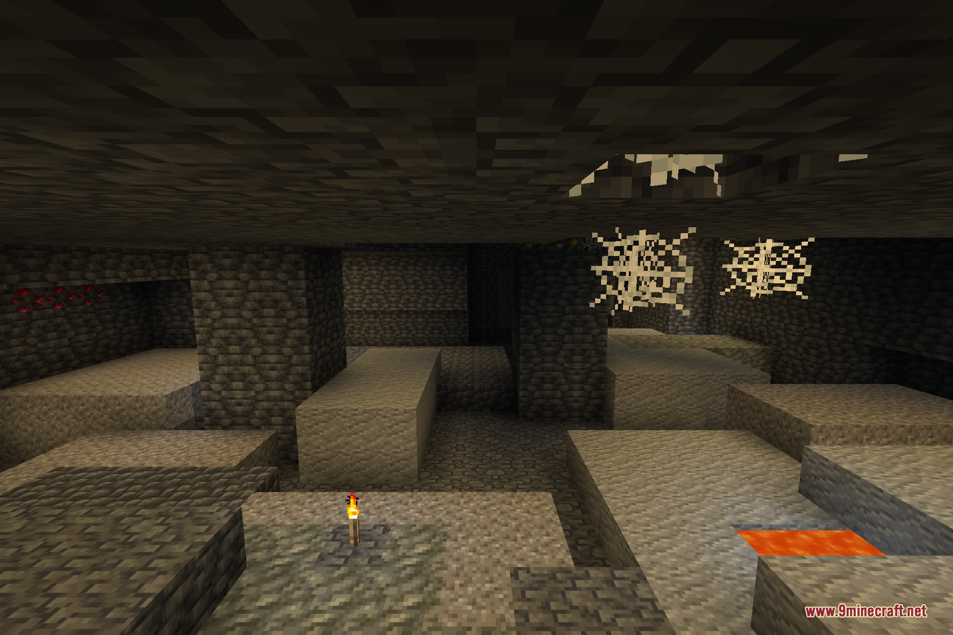 A torch-lit deepslate cavern with ore veins and a lava pool