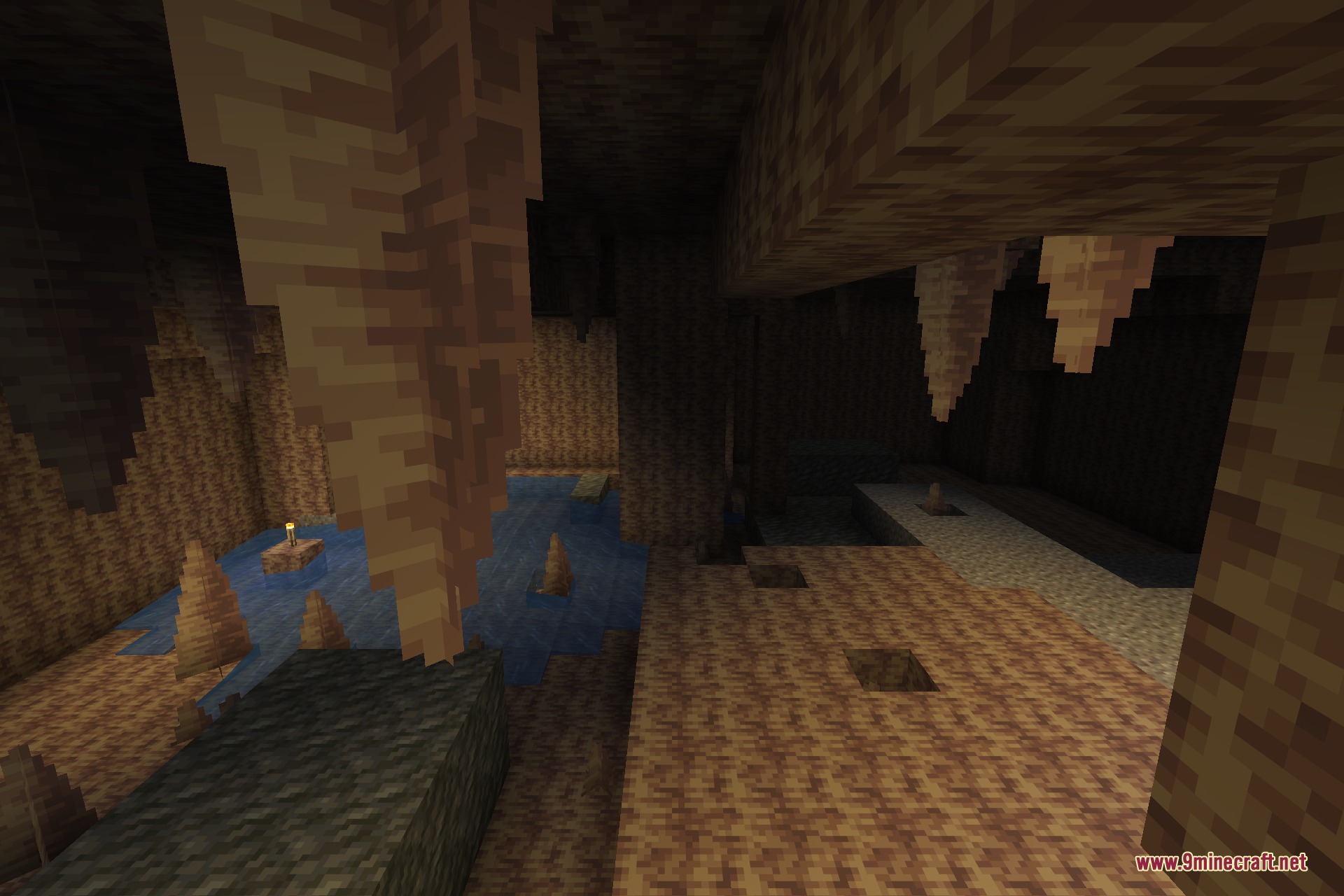 A dripstone cave with stalactites hanging over an underground pool