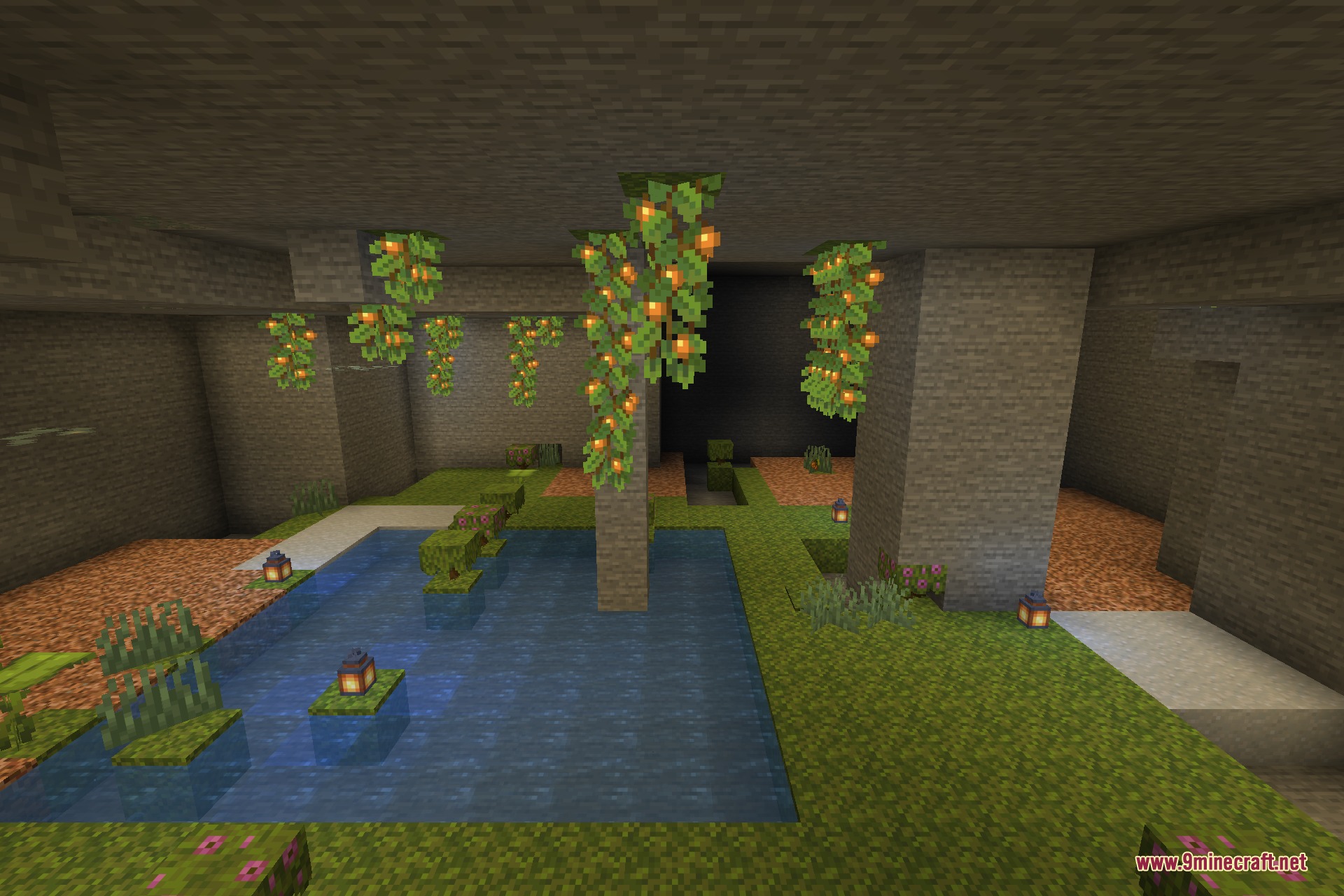 A lush cave lit by glow berry vines above a still pool