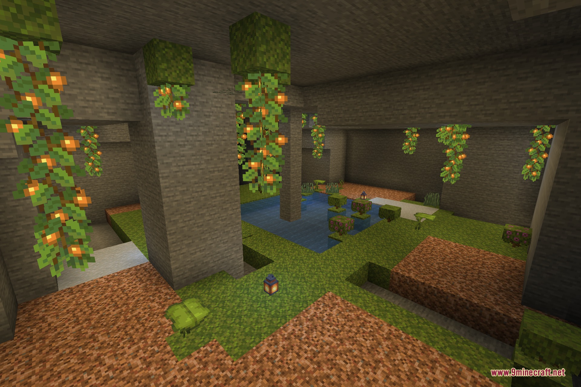 A wide view across the lush cave with moss, azalea and dripleaf