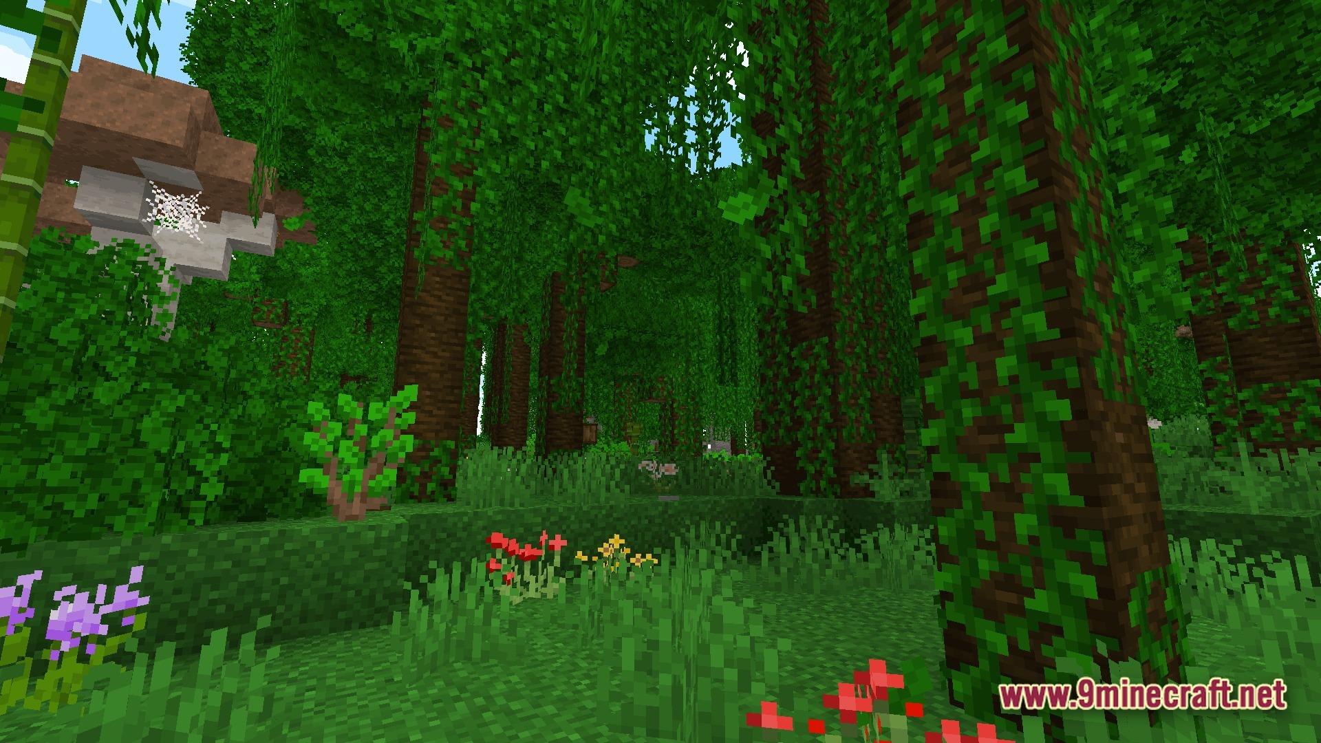 A dense jungle biome featuring tall trees covered in vines, wild flowers, and a large mushroom