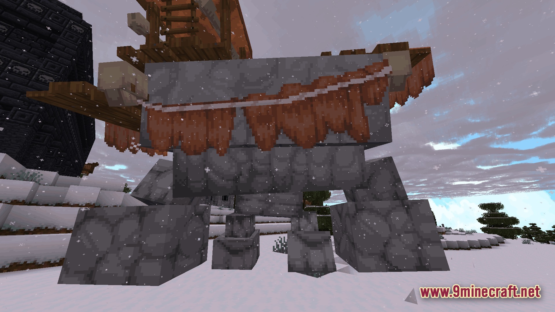 A large stone golem creature carrying a wooden structure stands in a snowy mountain biome
