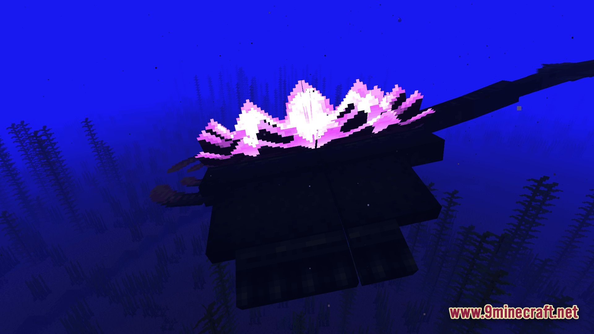 A large aquatic creature with a glowing pink dorsal structure swims through a deep ocean biome