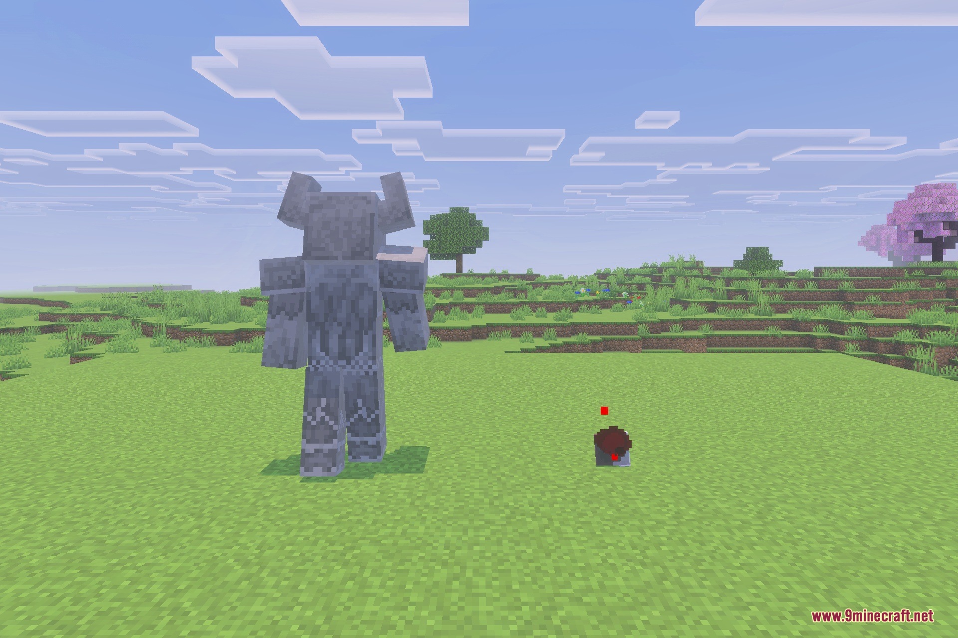 A giant stone golem with horns stands in a grassy plain