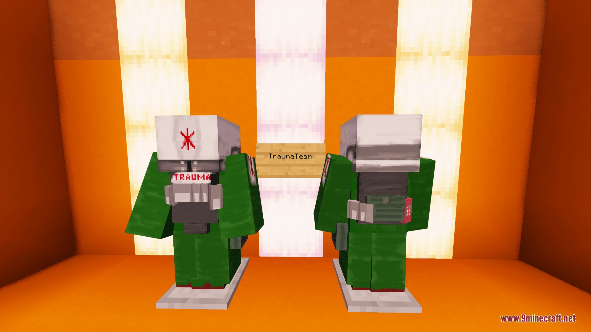 Two armor stands displaying green and white Trauma Team medical suits