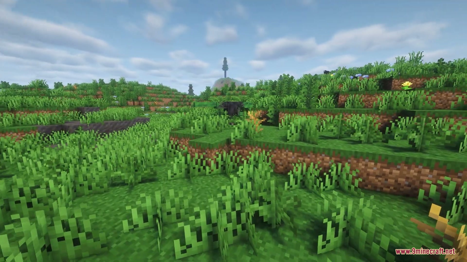 Nomad Horizon Expanded Mod Screenshot 2 Lush green hills and prehistoric animals under a cloudy sky in Minecraft
