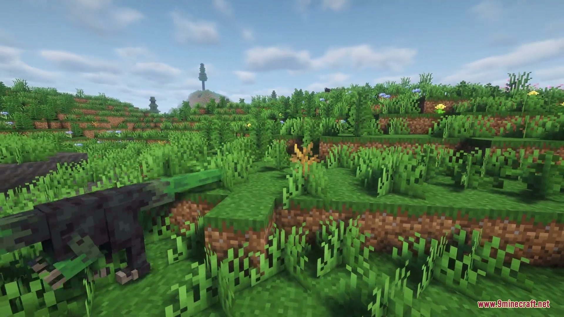 Nomad Horizon Expanded Mod Screenshot 4 A prehistoric dinosaur walks through a grassy landscape in the Minecraft world