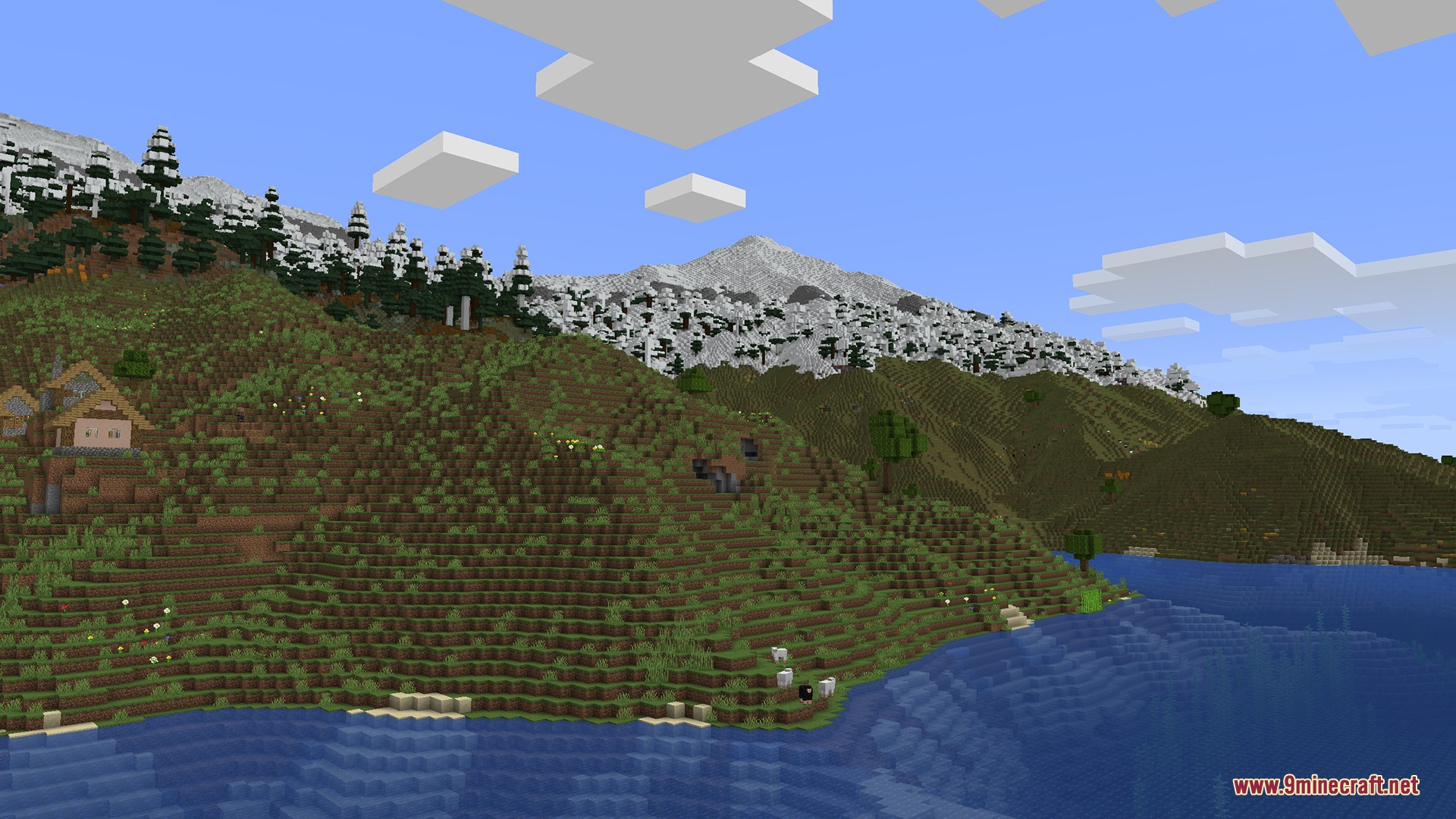 Pixel Canvas Terrain Mod Screenshot 2 Grassy hills along a blue lake with snowy mountains in the background