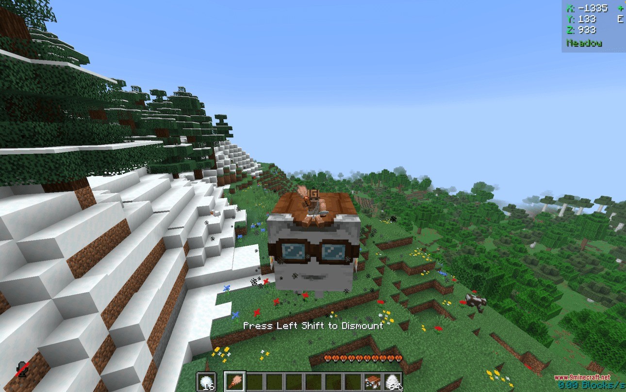 Player riding a small Happy Ghast over a snowy mountain in Minecraft