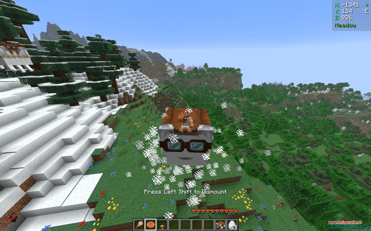 Player riding a small Happy Ghast with goggles over a scenic flower meadow