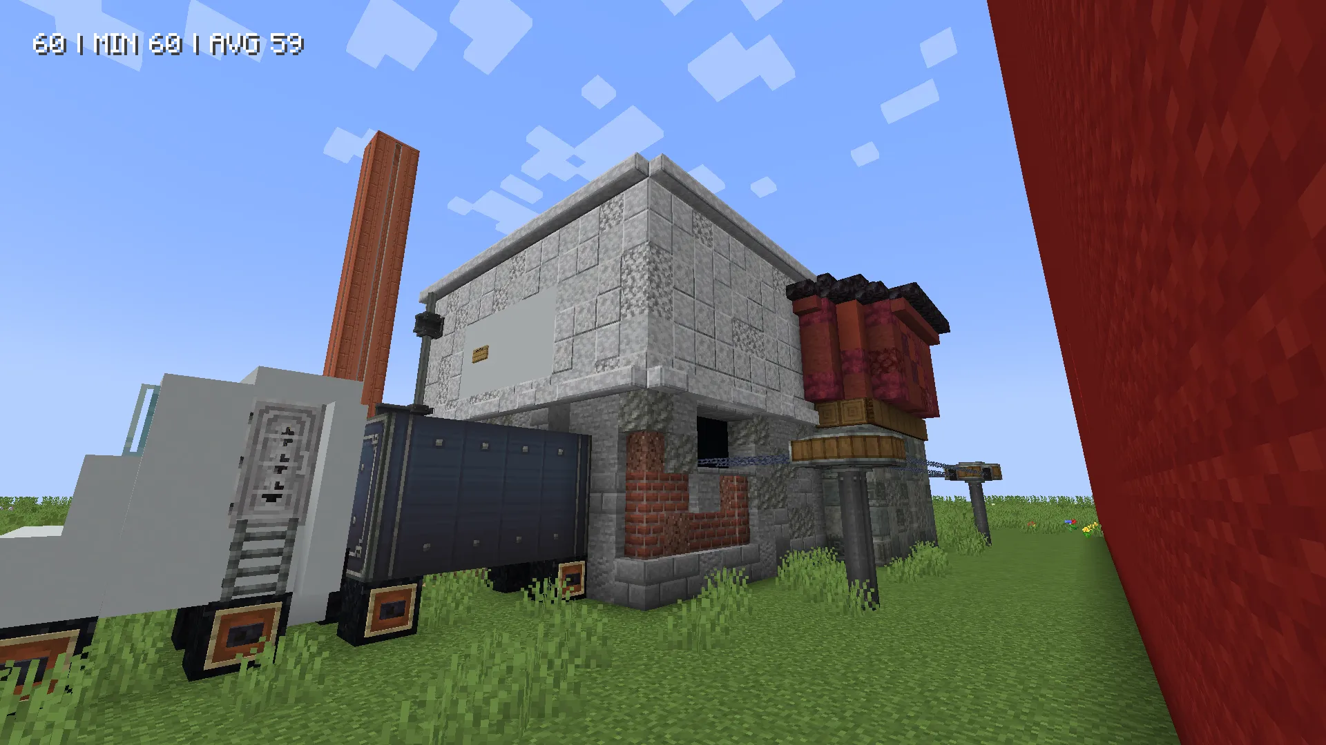 A white truck parked beside a stone building with a tall orange pillar