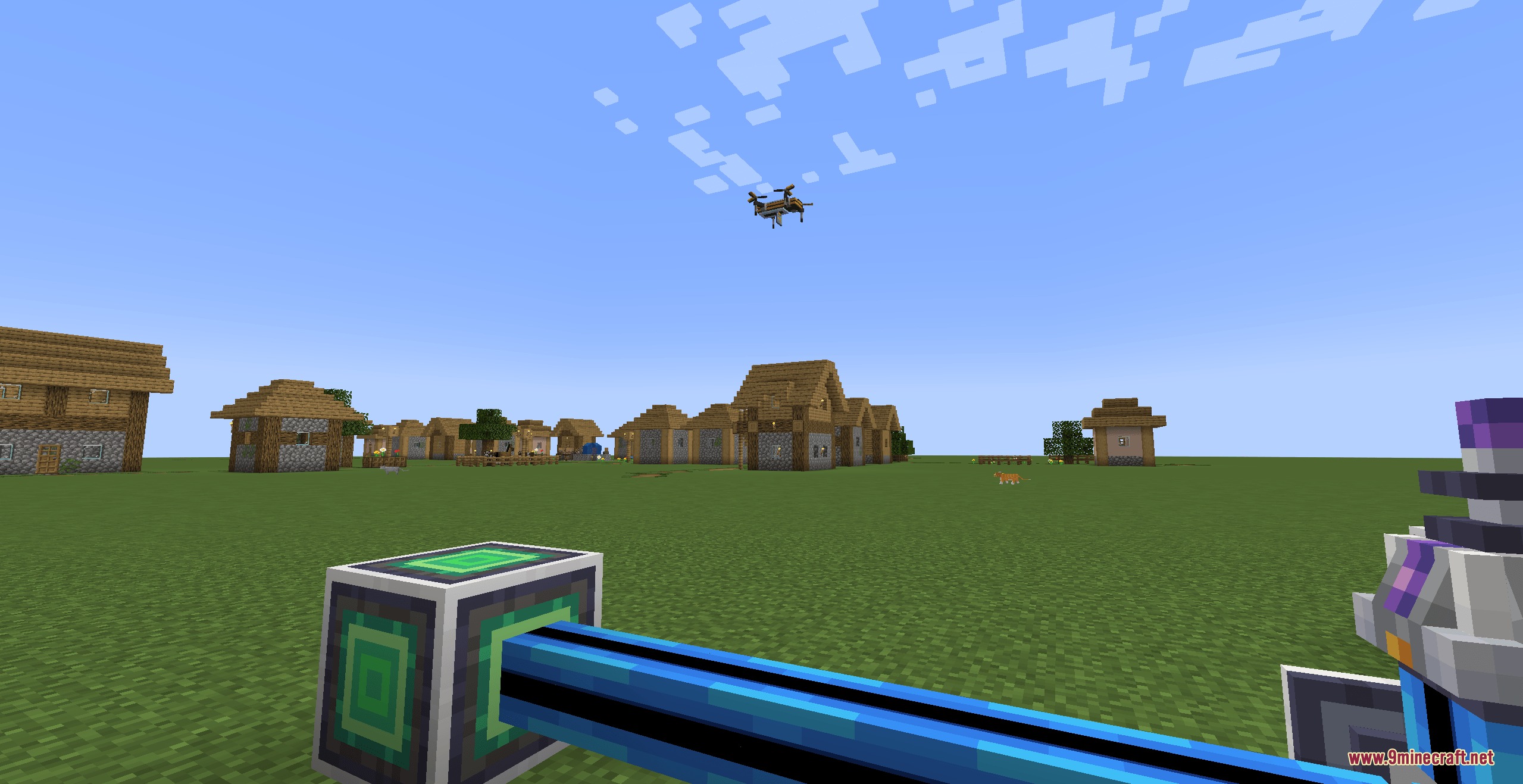 A drone flies over a village while player holds a blue logic cable