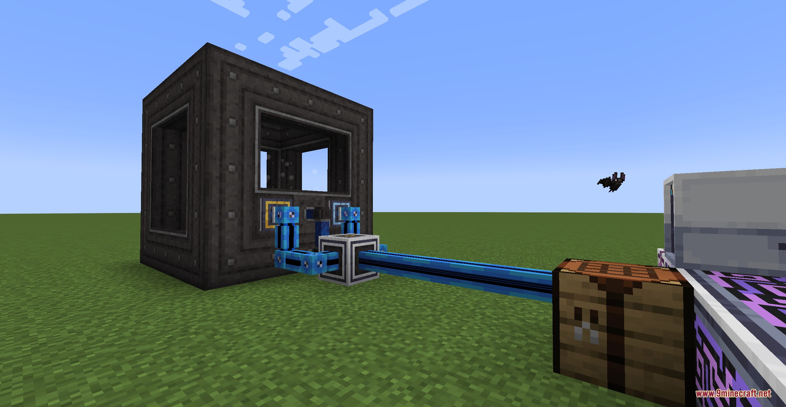 Blue cables connecting a pressure chamber to a crafting table and blocks