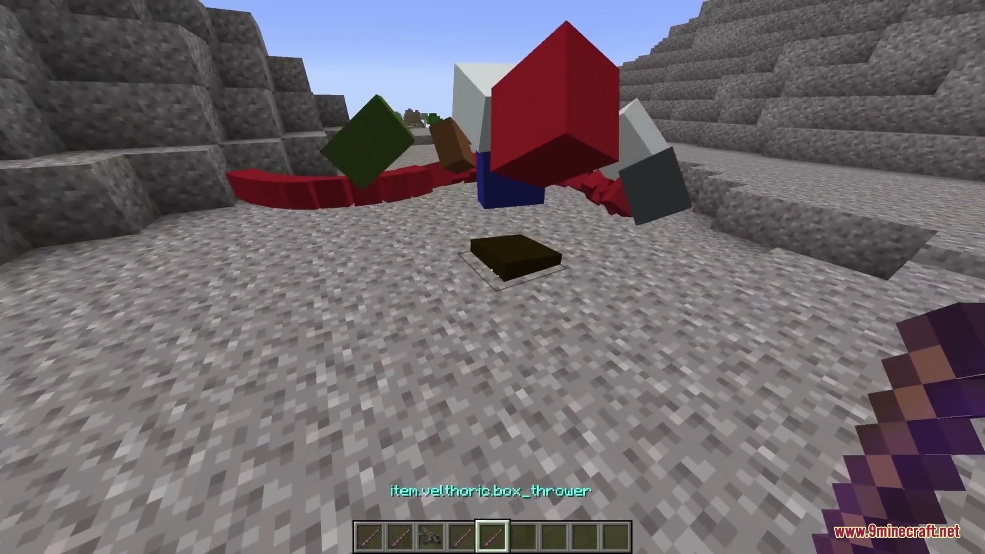 Primal Aether Surge Mod Screenshot 11 A player uses a box thrower tool to launch colorful physics blocks