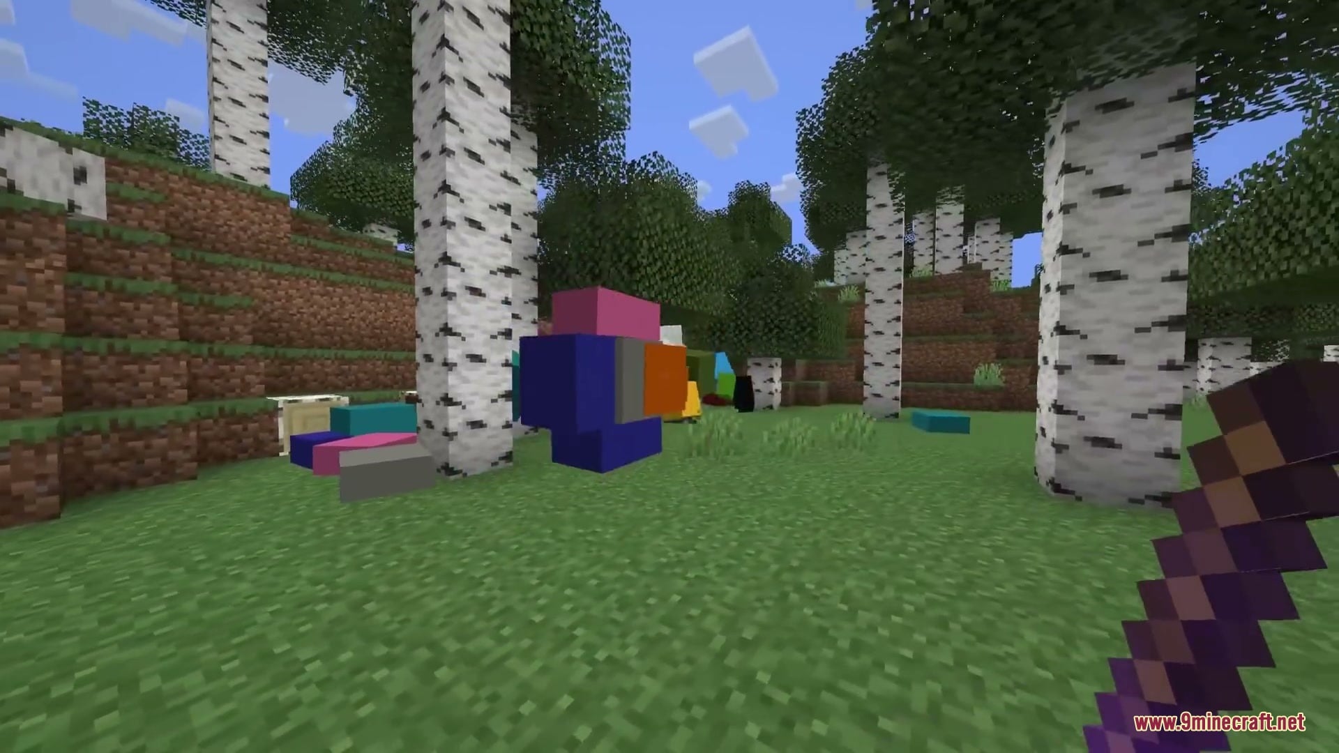 Primal Aether Surge Mod Screenshot 5 Player using a magnetizer tool to manipulate colorful physics blocks in a forest
