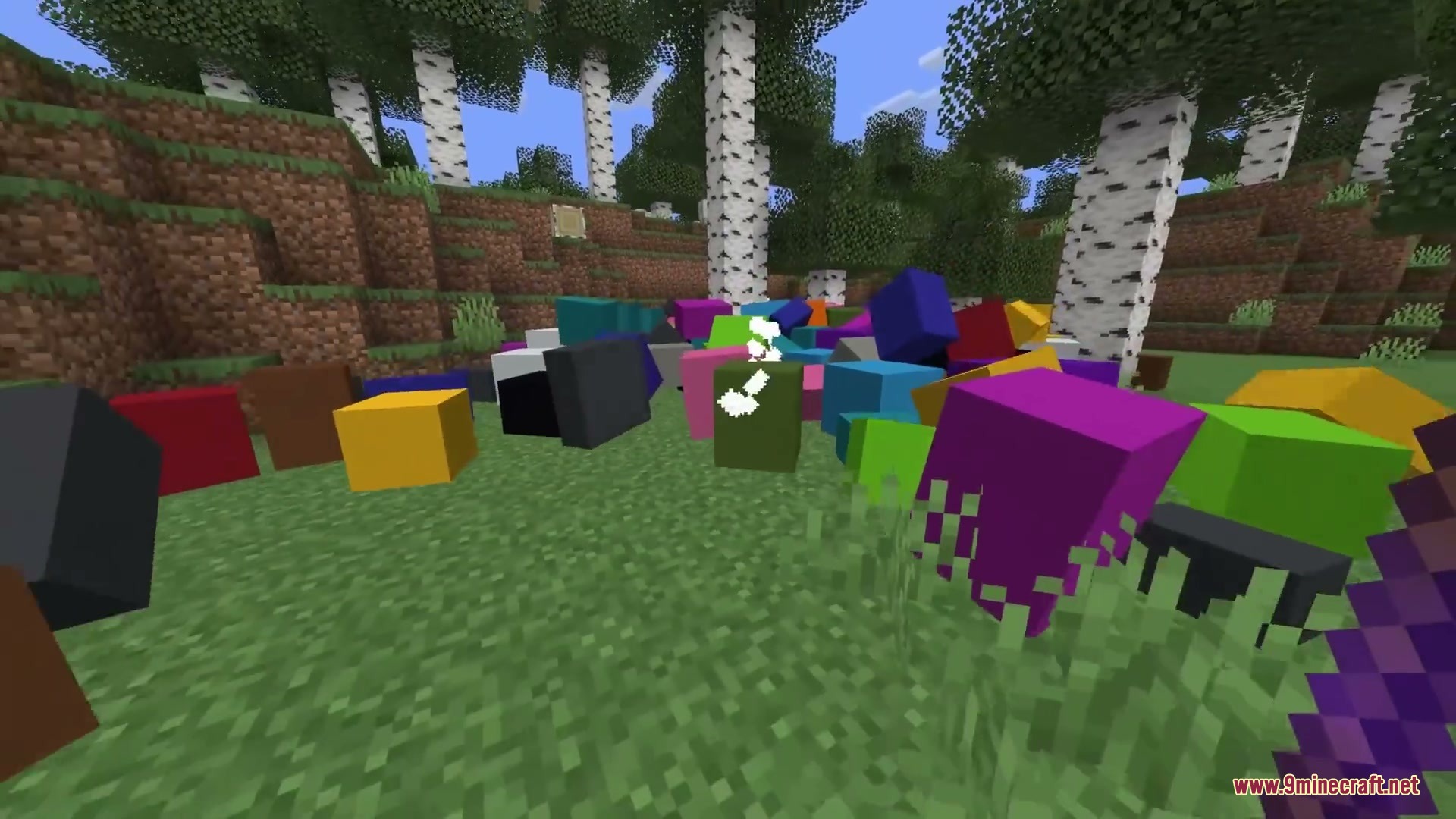Primal Aether Surge Mod Screenshot 7 A pile of colorful physics enabled blocks scattered on the grass in a forest