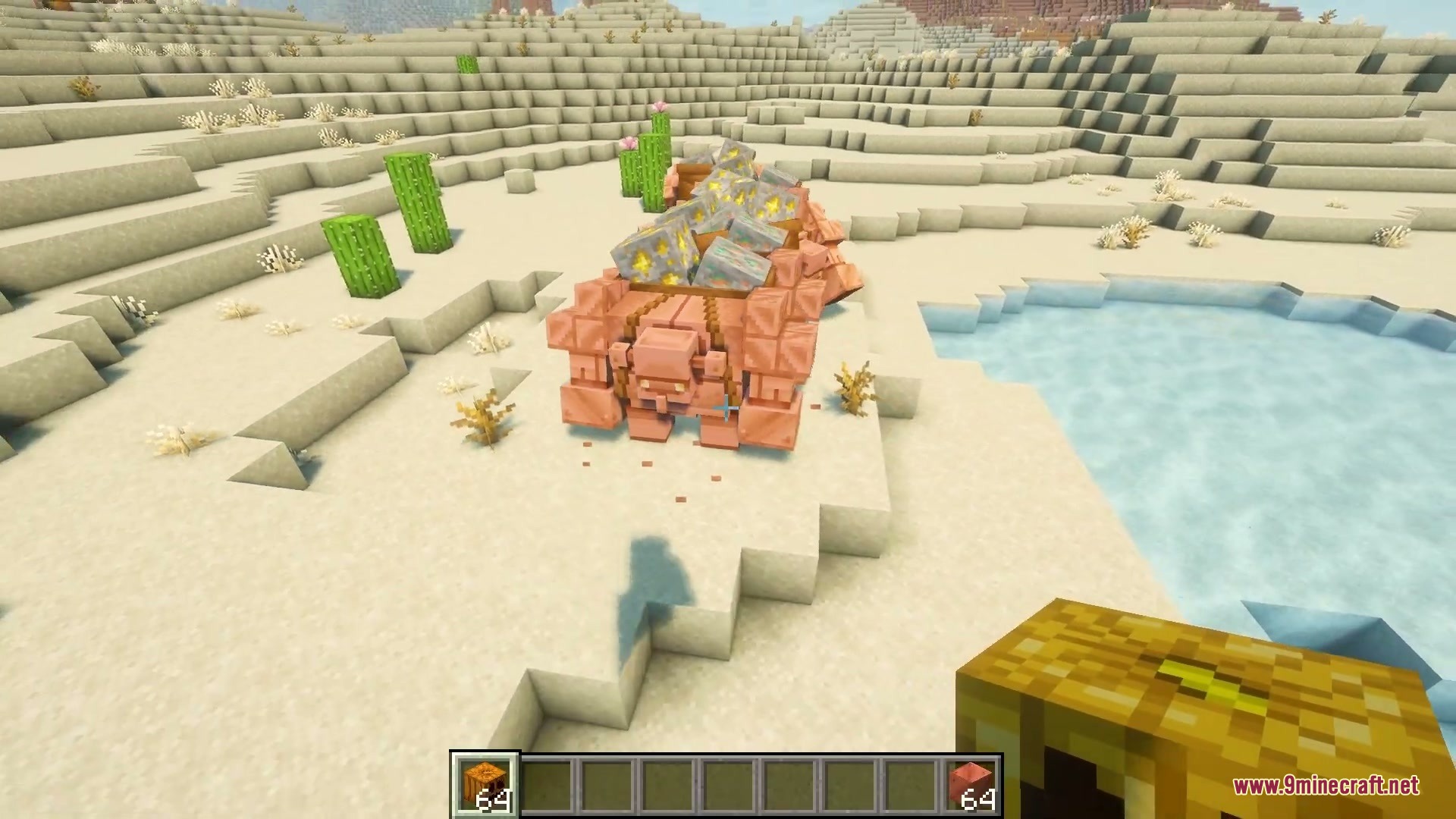 Primal Appetite Mod Screenshot 2 A copper golem carrying gold ore walks through a desert near water